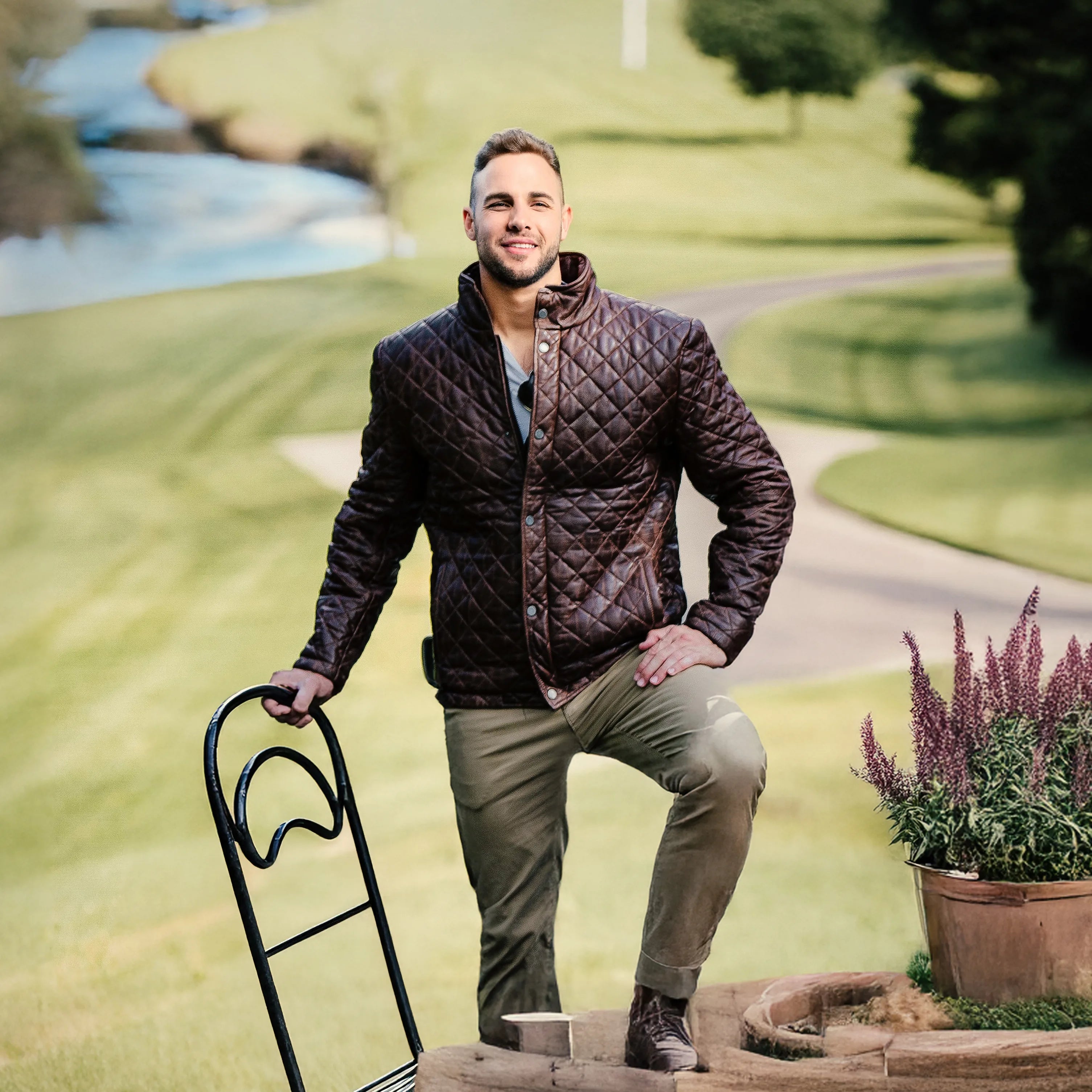 Man in a quilted jacket standing outdoors with a garden cart and potted plant.