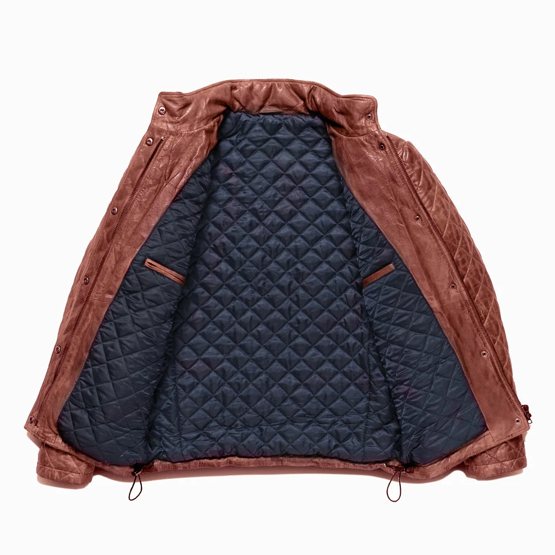 Brown leather jacket with quilted navy interior on a white background