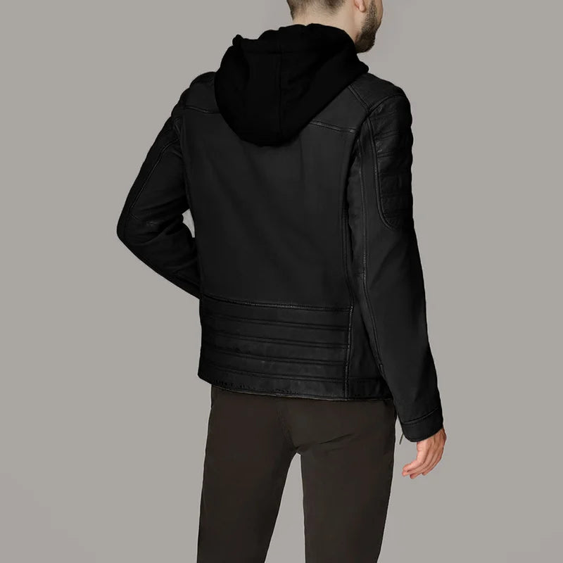 Person wearing a black leather jacket with a hood on a gray background