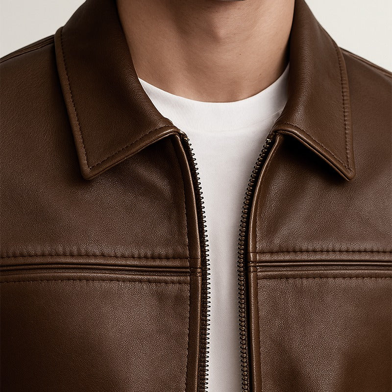 Brown leather jacket worn by a person with a white shirt underneath