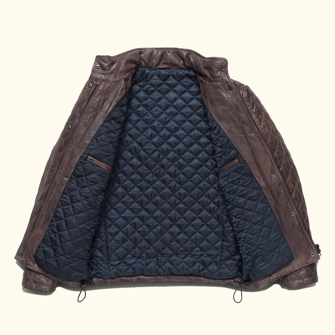 Brown leather jacket with quilted navy interior on a white background