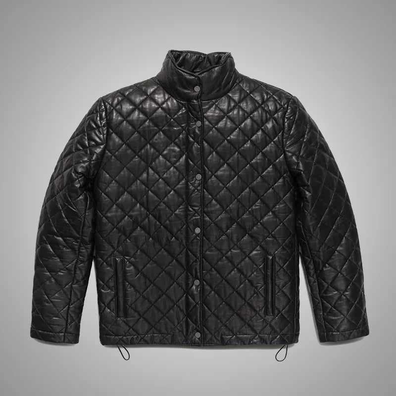 Black quilted jacket on a gray background