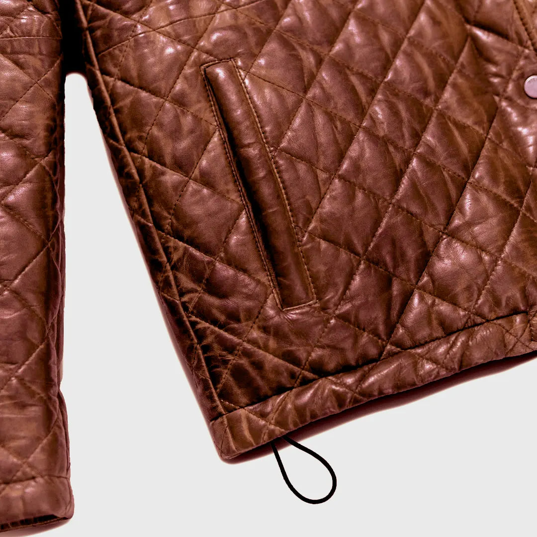 Brown quilted jacket on a light gray background