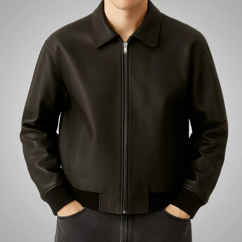 Black leather jacket worn by a person on a gray background