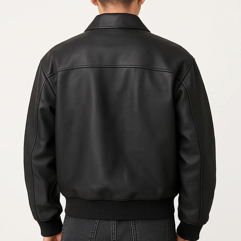 Black leather jacket worn by a person on a plain background