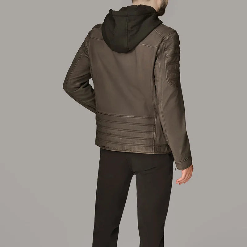 Person wearing a brown leather jacket with a black hood on a gray background