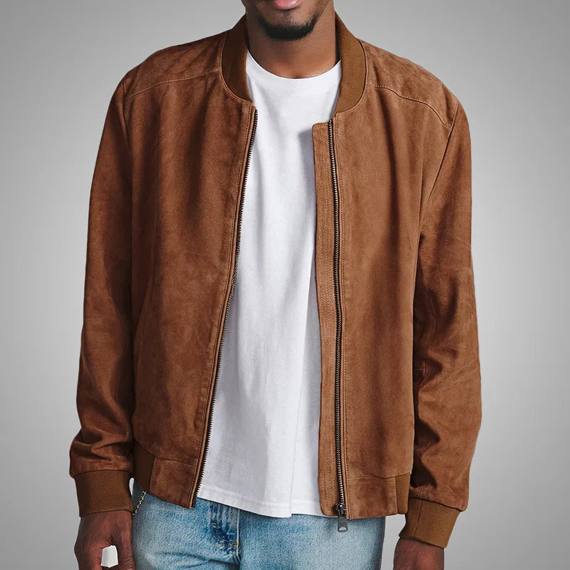 Man wearing a brown suede jacket over a white shirt with a gray background