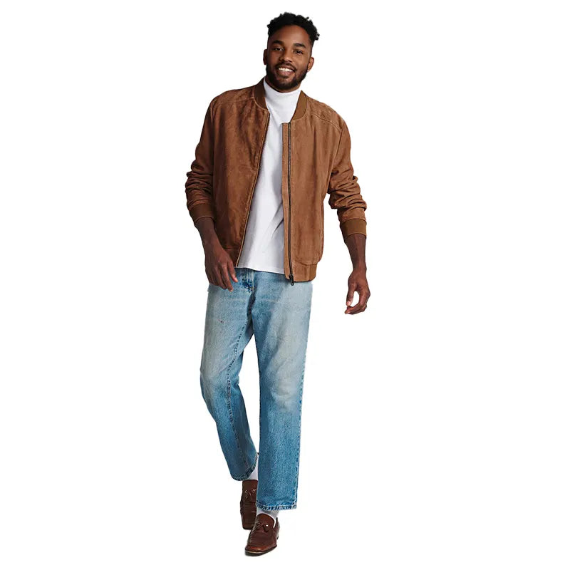 Man wearing a brown jacket, white shirt, and blue jeans on a white background