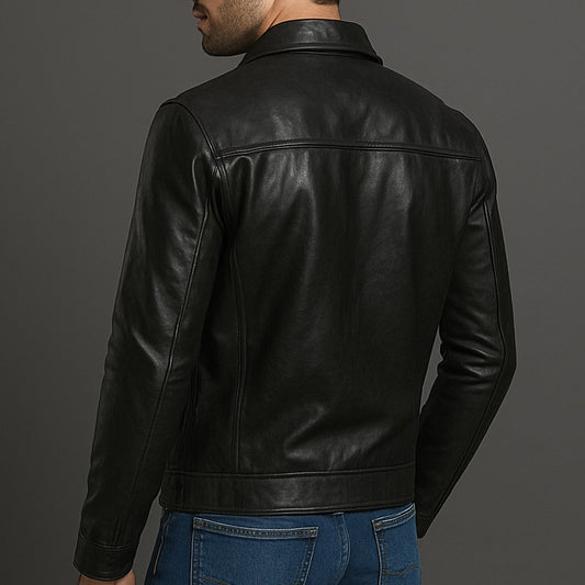 Man wearing a black leather jacket on a gray background
