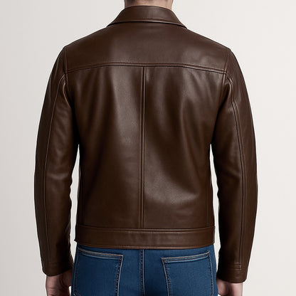 Brown leather jacket worn by a person on a plain background