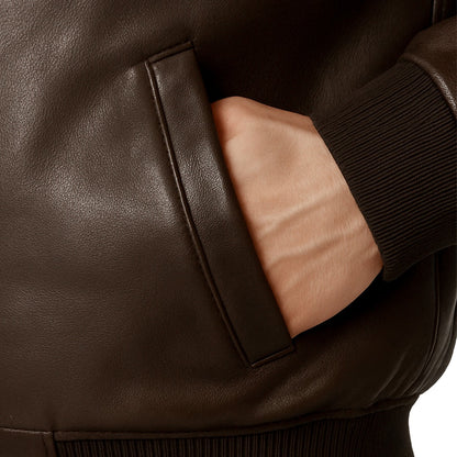 Close-up of a brown leather jacket with a pocket.