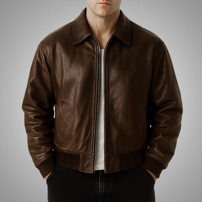 Brown leather jacket worn by a person on a gray background