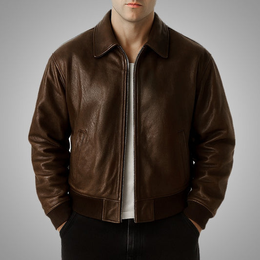 Brown leather jacket worn by a person on a gray background