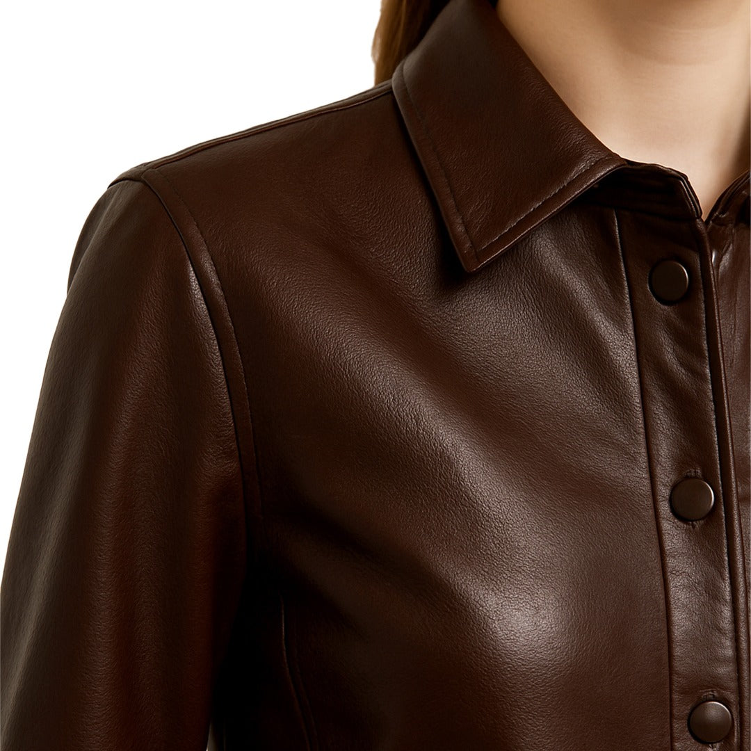 Close-up of a brown leather jacket with a white background
