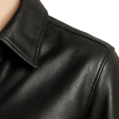 Close-up of a black leather jacket with a focus on texture and stitching.